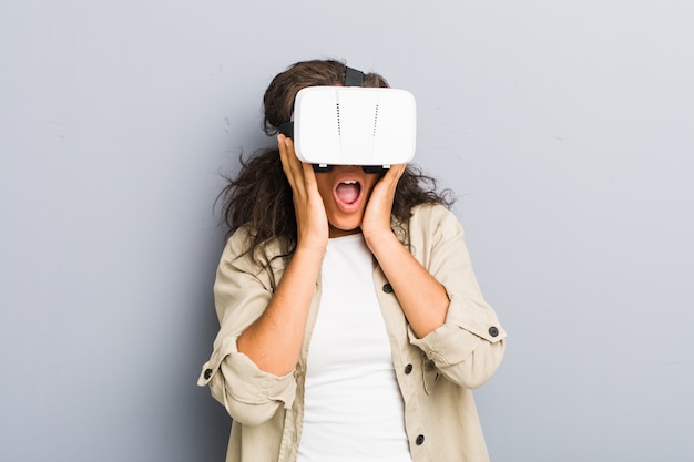 Young african american woman using a virtual reality glasses