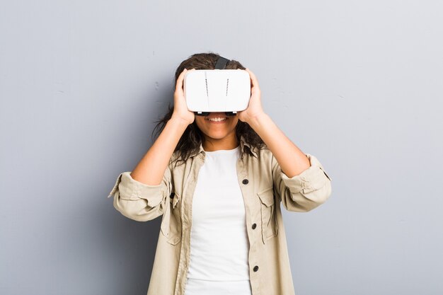 Young african american woman using a virtual reality glasses