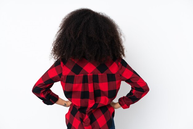 Young african american woman over wall in back position