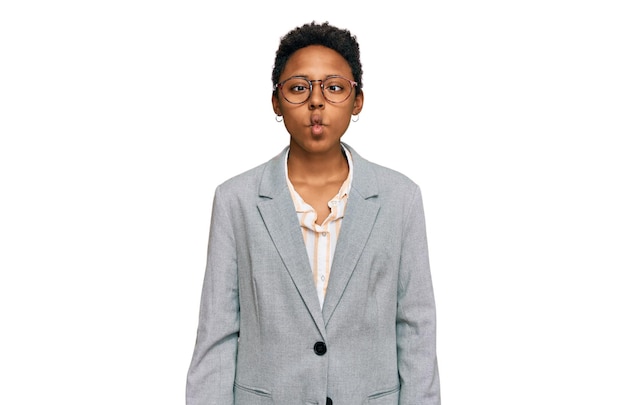 Young african american woman wearing business clothes making fish face with lips crazy and comical gesture funny expression