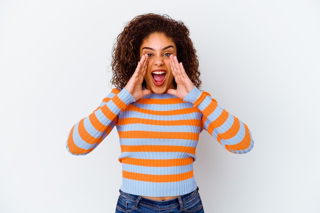 Young african american woman on white shouting excited to front.