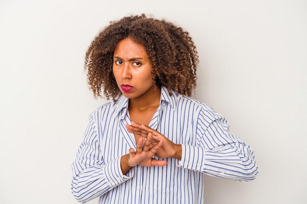 Young african american woman with curly hair isolated on white background doing a denial gesture