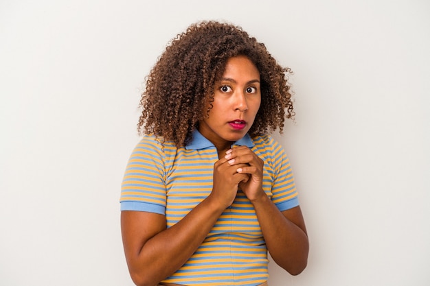 Young african american woman with curly hair isolated on white background scared and afraid.