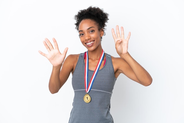 Young African American woman with medals isolated on white background counting nine with fingers