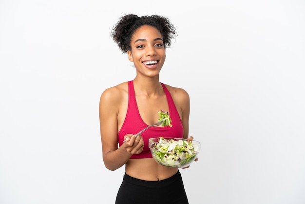 Young african american woman with salad isolated on white background holding a bowl of salad with happy expression