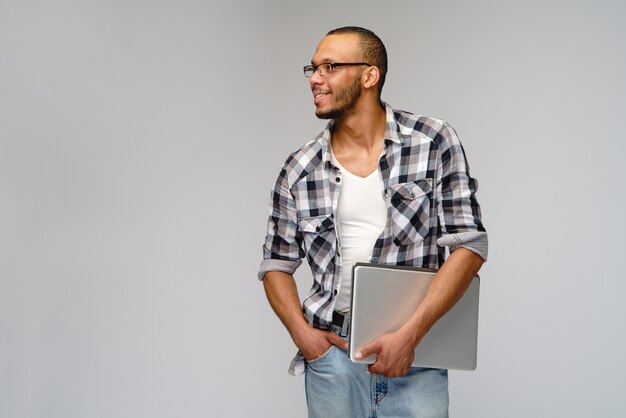 Young African-American young man over light gray background