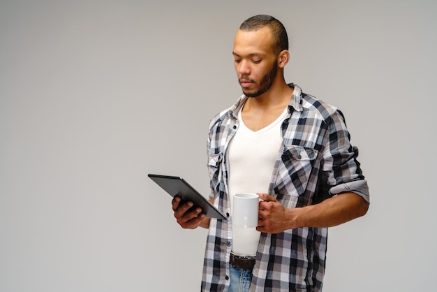 Young African-American young man over light grey background