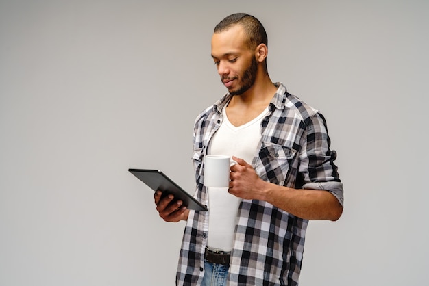 Young African-American young man over light grey background