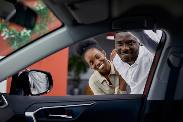 Young african couple is interested in auto