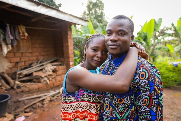 Young African couple in love embraced in front of their house in the village