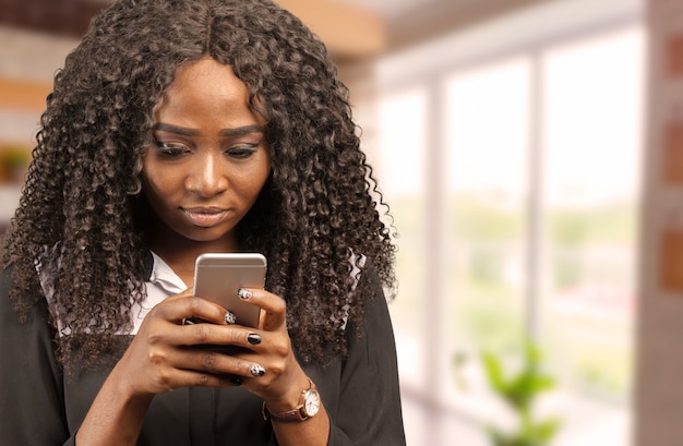 Young african lady chatting by phone