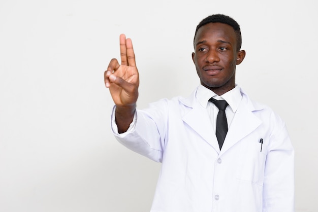 young African man doctor isolated against white space