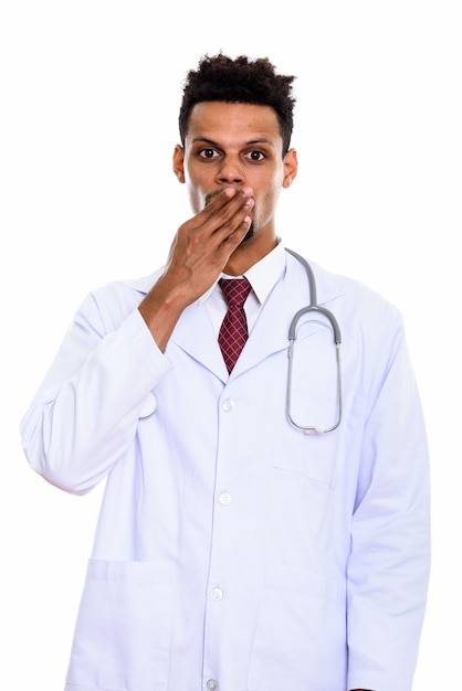 young African man doctor looking shocked isolated on white