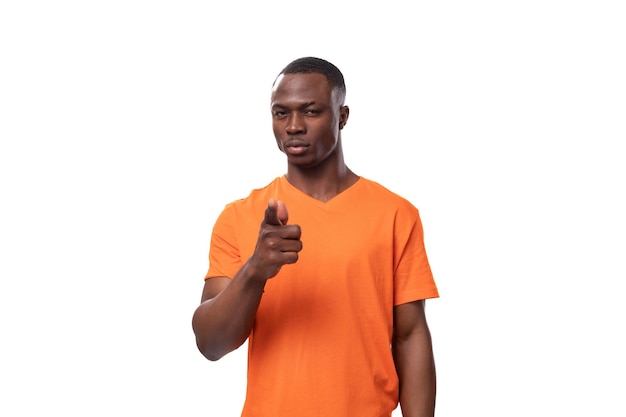 young african man dressed in orange tshirt brainstorming and remembering thoughts