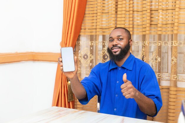 Young African Man Excitedly Looking at Phone