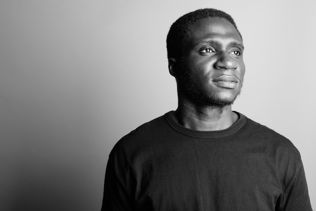 young African man wearing black shirt. black and white