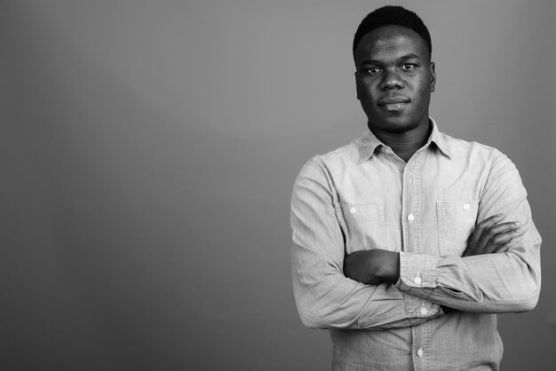 Photo young african man wearing denim shirt. black and white photo