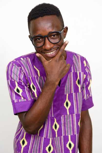 Young african man wearing traditional ethnic clothing isolated against white space