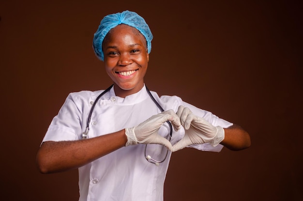 Young african nigerian woman preventing prevent prevented herself from the outbreak in his society and did a love sign