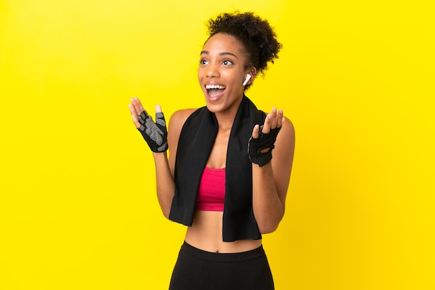 Young African sport woman isolated on yellow background with surprise facial expression