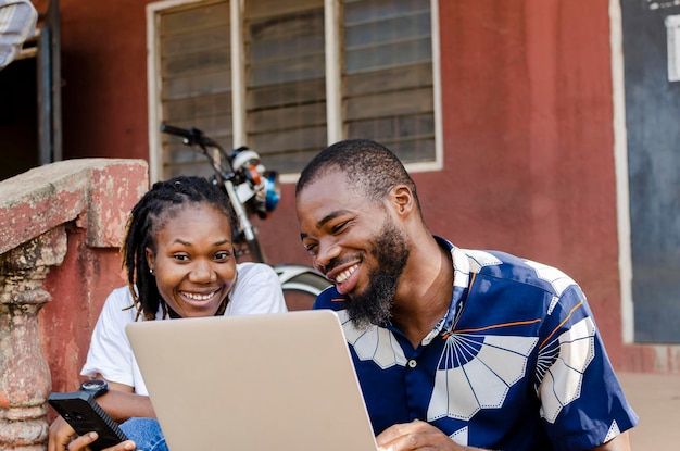 Young african students using laptop and mobile phone to study online