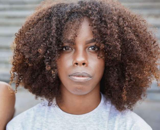 Young african woman looking serious on camera