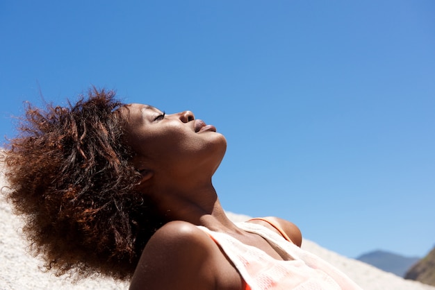 Young african woman relaxing outdoors