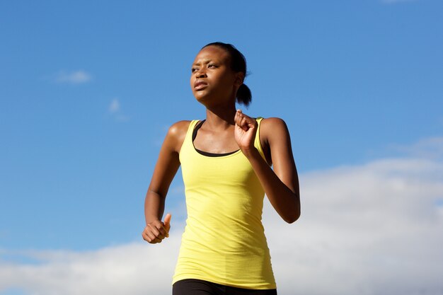 Young african woman running outdoors