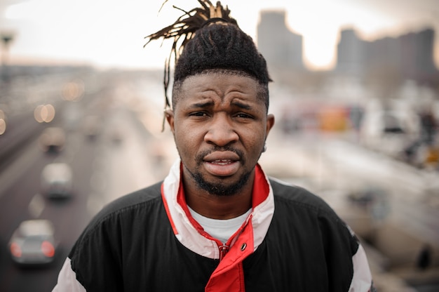 Young afro-american man standing on the city