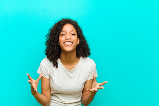 young Afro-American woman posing while showing excitement