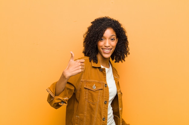 young Afro-American woman posing while showing thumbs up