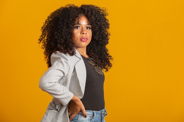 Young afro-american woman with curly hair  and smiling. Cute afro girl with curly hair smiling 