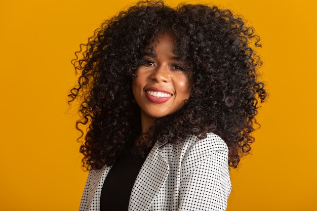 Young afro-american woman with curly hair  and smiling. Cute afro girl with curly hair smiling 