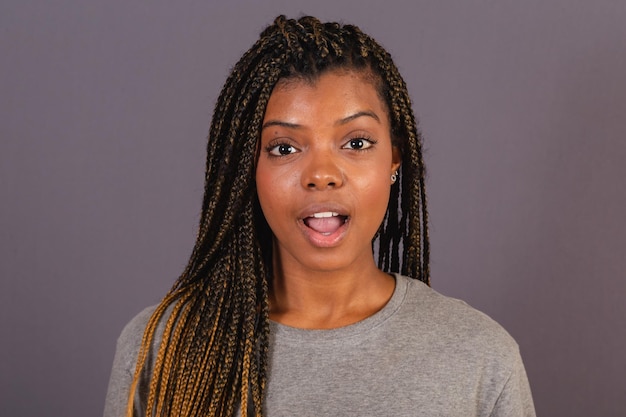 Young afro brazilian woman close up photo showing facial expression surprised