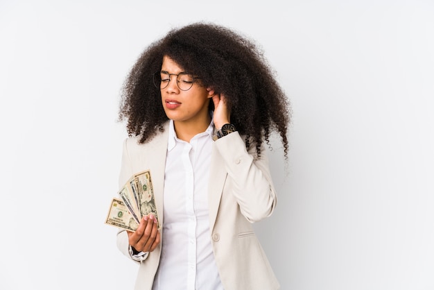 Young afro business woman holding a credit car isolated Young afro business woman holding a credit carcovering ears with hands.