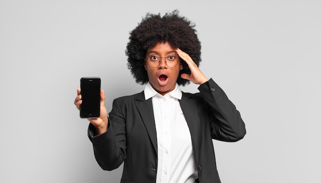 Young afro businesswoman looking happy