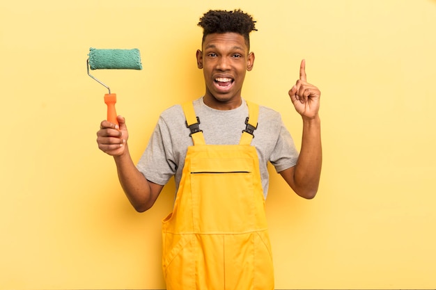 young afro man against yellow wall