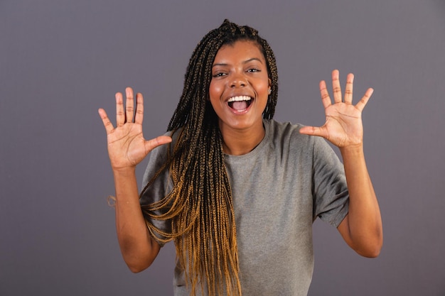 Young afro woman brazilian surprised wow incredible\
unbelievable amazed