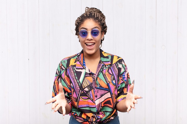 Young afro woman feeling happy, astonished isolated