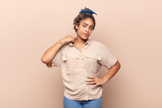 Young afro woman feeling stressed, anxious, tired and frustrated, pulling shirt neck, looking frustrated with problem