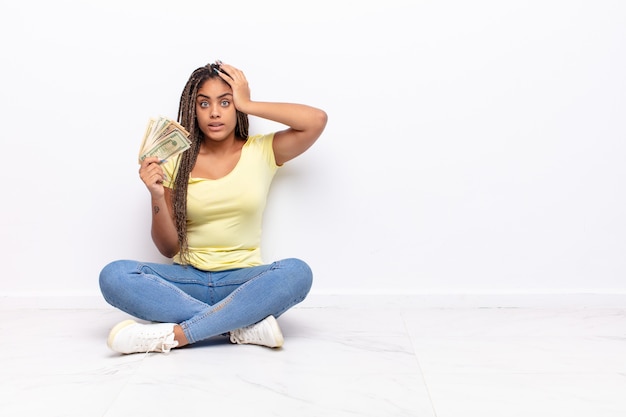 Young afro woman feeling stressed, worried, anxious or scared, with hands on head