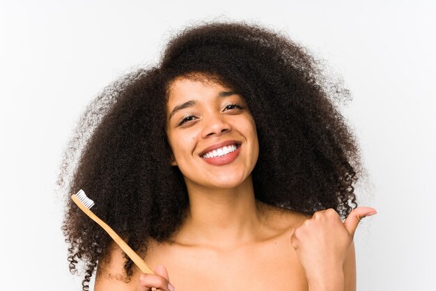 Young afro woman holding a teeth brush