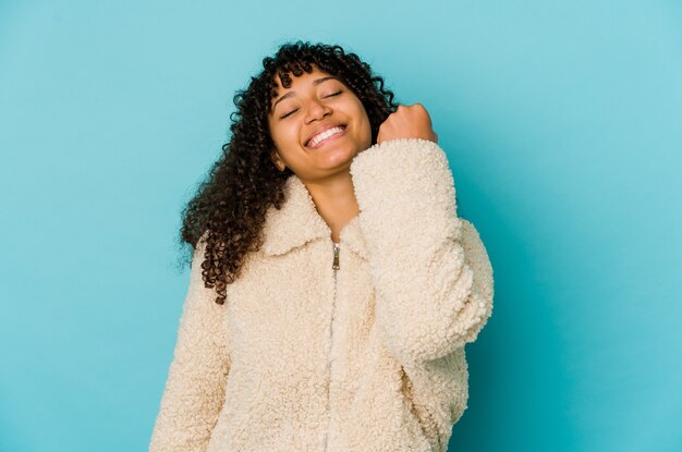 Young afro woman isolated celebrating a victory, passion and enthusiasm, happy expression