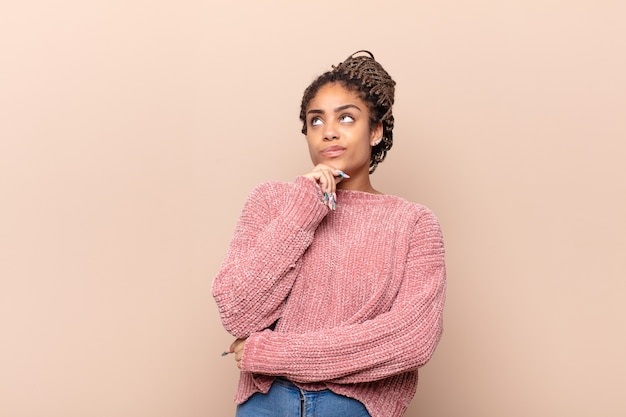 Young afro woman looking thoughtful