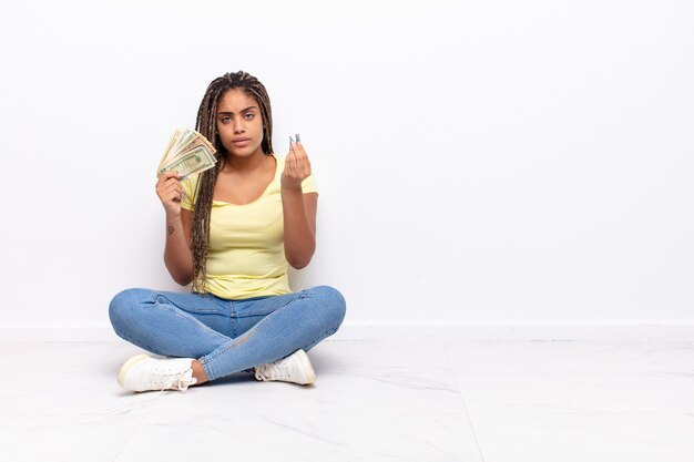 Young afro woman making capice or money gesture, telling you to pay your debts!. money concept