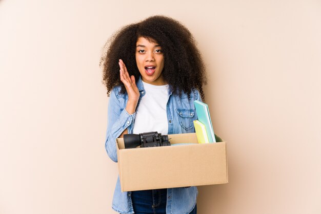 Young afro woman moving home isolated Young afro woman surprised and shocked.