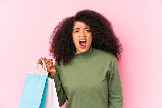 Young afro woman shopping isolated