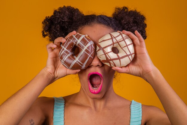 Young afro woman with donuts