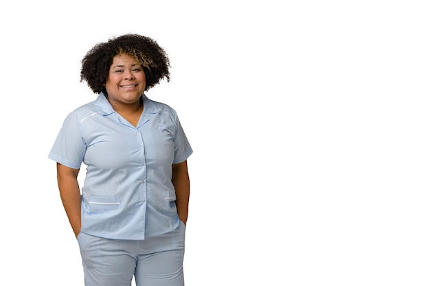 young AfroLatin female doctor in blue uniform smiling and looking at the camera white background