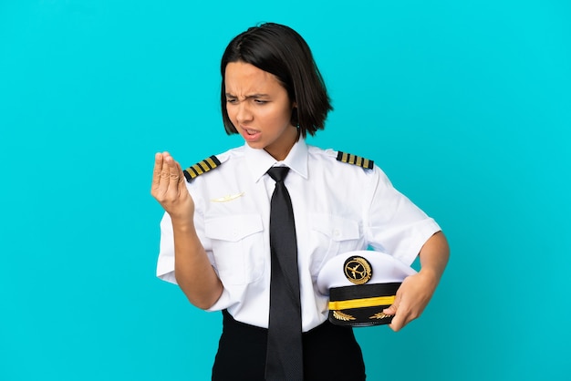 Young airplane pilot over isolated blue background suffering from pain in hands